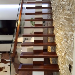 Wooden stairs with glass balustrade