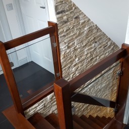 Wooden stairs with glass balustrade
